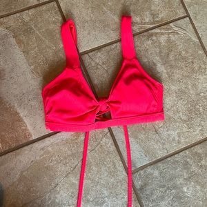 Target hot pink bathing suit top, knot in front and tie back. Adjustable straps.